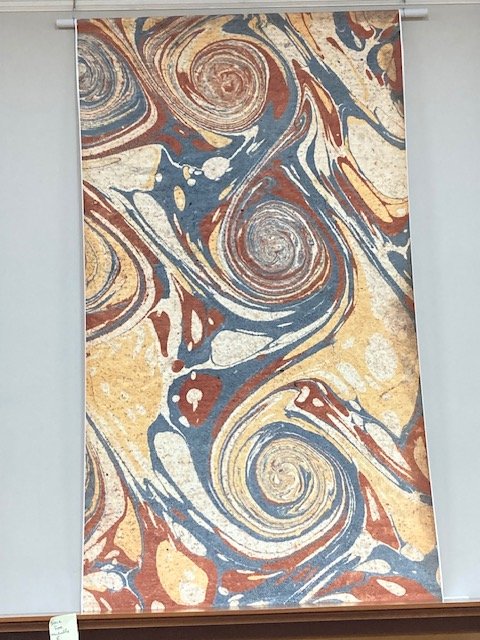 Wall hanging illustrating a French curl motif